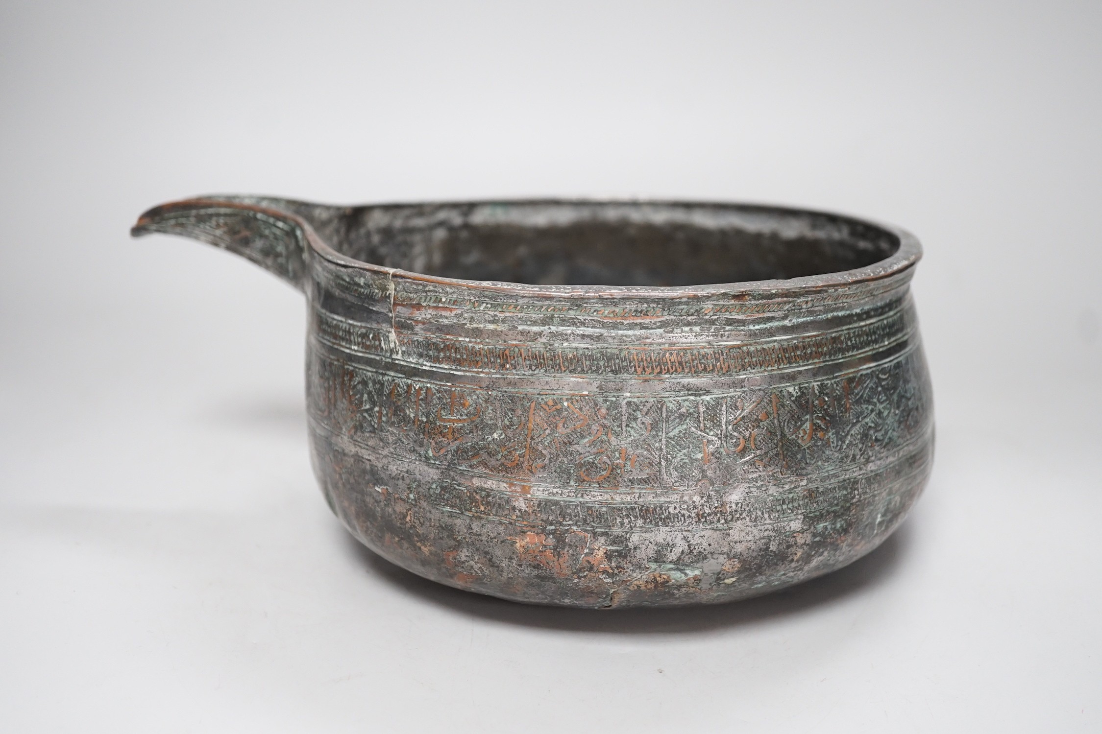 An early Islamic tinned copper pouring vessel, Egypt or Syria, 26cm long, Kufic inscriptions